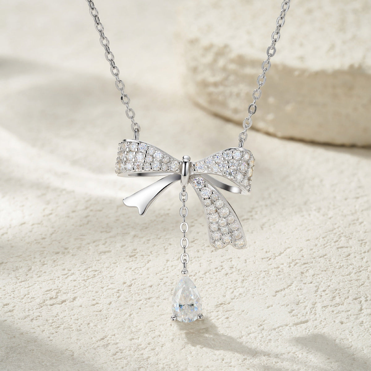 Belle Pear-Cut Moissanite Bow Pendant Necklace in Sterling Silver